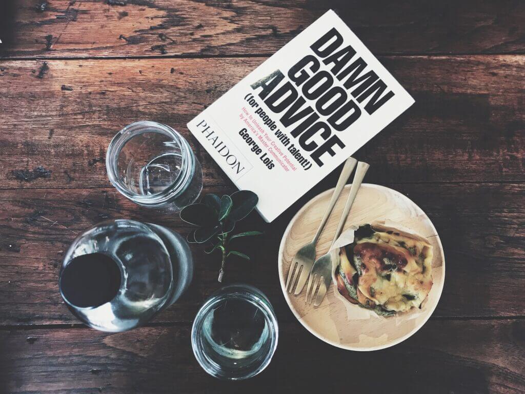 book food and glasses on table